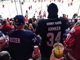 Fans enjoying Hinny Hard Seltzer at a hockey game.