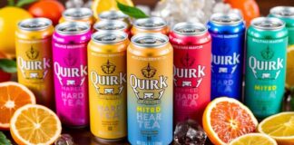 Colorful cans of Quirk Hard Tea with citrus fruits.