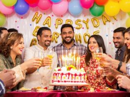 People celebrating with balloons and cake at an event.